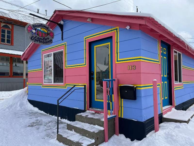 The pink and periwinkle Blueflower shop in Leadville in the snow